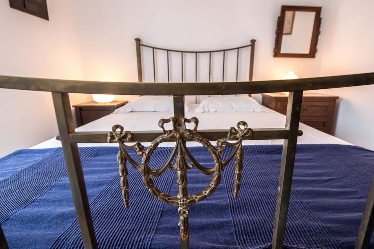 Bedroom at Villa Ilios with a wrought-iron double bed