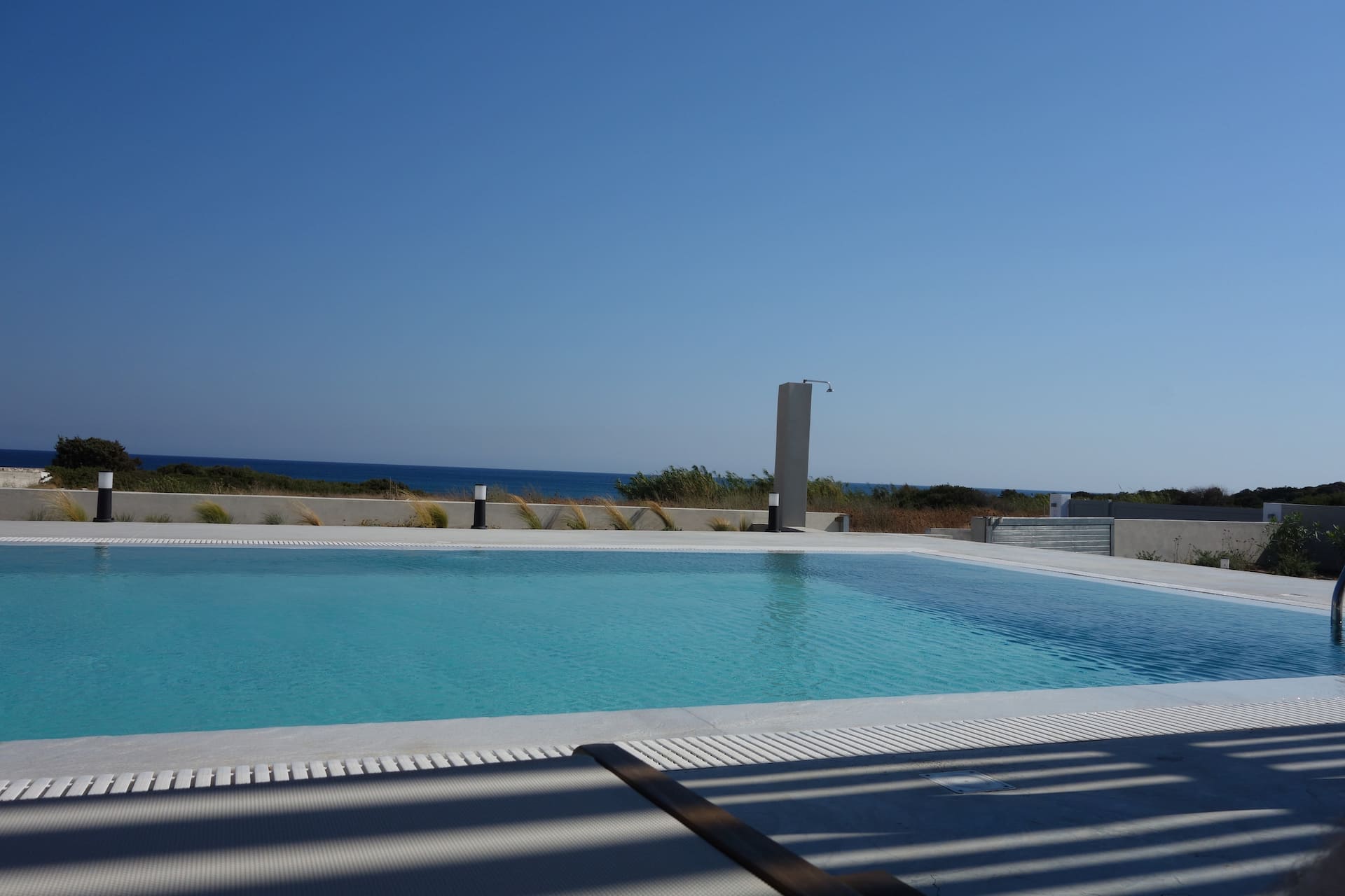 Private pool at Villa Ilios with sun loungers and a view over the sea