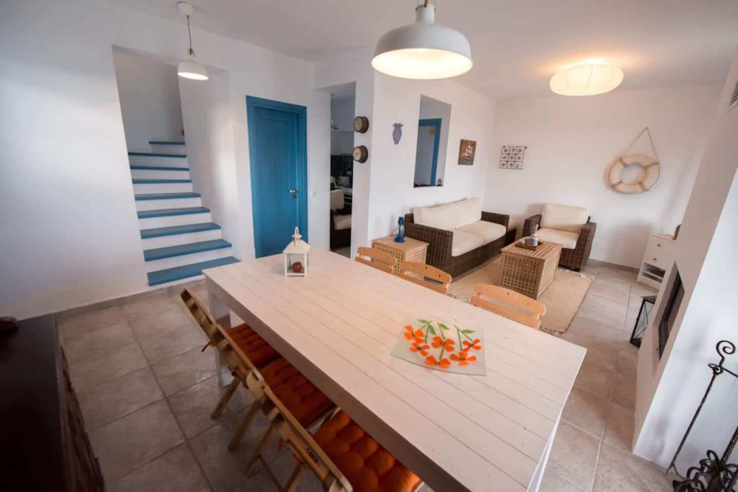 Open-plan living and dining area inside Villa Ilios